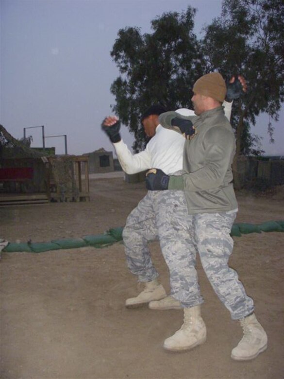 Airmen deployed to the 332nd Expeditionary Logistics Readiness Squadron, Marine Corps Air Base Al Taqaddum (TQ), Iraq, practice elbow-assault techniques during a Marine Corps Martial Arts Program training session. In addition to performing their assigned Air Force duties, many of the nearly 50 Airmen deployed to TQ also participate in MCMAP training and some even attend Marine Corps Professional Military Education by attending the Marine version of Airman Leadership School, Corporal’s Course, while there. (U.S. Air Force photo/Marine Cpl. Brandon Uhrich)