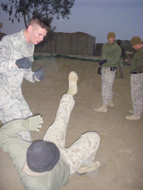 Airman 1st Class Steven Cash, deployed to the 332nd Expeditionary Logistics Readiness Squadron, Marine Corps Air Base Al Taqaddum (TQ), Iraq, uitilizes a recently learned Marine Corps Martial Arts Program training technique to throw a fellow Marine during a MCMAP training session Jan. 28. The Airman, deployed from the 436th Aerial Port Squadron, is one of nearly two dozen Dover Airmen deployed to TQ and working and training with the Marines there. In all, there are nearly 50 Airmen deployed to TQ. (U.S. Air Force photo/Marine Cpl. Brandon Uhrich)