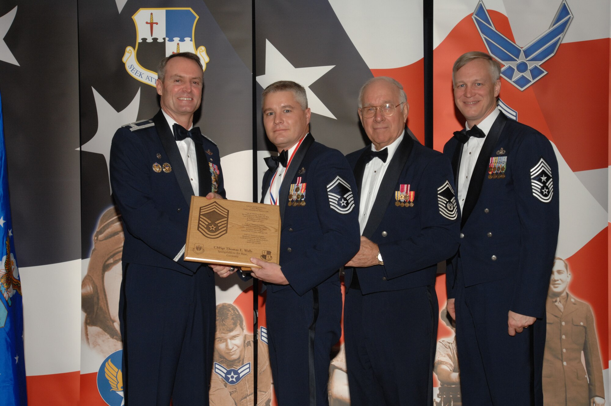 SPANGDAHLEM AIR BASE, Germany – Senior Master Sgt. Thomas Walls, 52nd Logistics Readiness Squadron, receives a plaque from Col. Darryl Roberson, 52nd Fighter Wing commander, Jan. 19, 2008 at Club Eifel. The plaque recognizes him as new chief master sergeant select. Sergeant Walls was also congratulated by retired Chief Master Sgt. of the Air Force Sam Parish and Chief Master Sgt. Vance Clarke, 52nd FW command chief. (U.S. Air Force photo/Airman 1st Class Jenifer Calhoun)