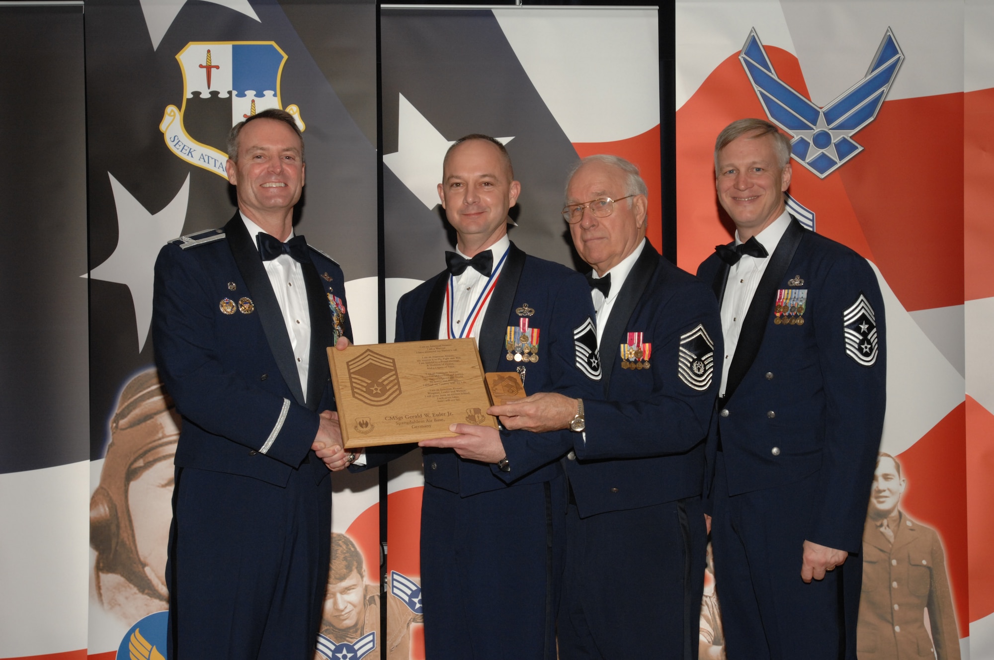 SPANGDAHLEM AIR BASE, Germany – Senior Master Sgt. Jay Euler, 703rd Munitions Maintenance Squadron, receives a plaque from Col. Darryl Roberson, 52nd Fighter Wing commander, Jan. 19, 2008 at Club Eifel. The plaque recognizes him as new chief master sergeant select. Sergeant Euler was also congratulated by retired Chief Master Sgt. of the Air Force Sam Parish and Chief Master Sgt. Vance Clarke, 52nd FW command chief. (U.S. Air Force photo/Airman 1st Class Jenifer Calhoun)