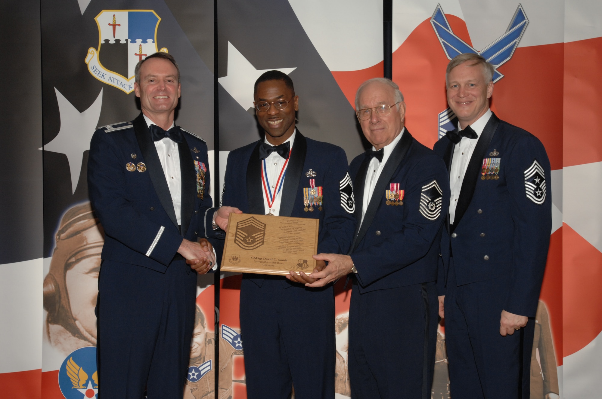 SPANGDAHLEM AIR BASE, Germany – Chief Master Sgt. David Smith, 52nd Operations Support Squadron, receives a plaque from Col. Darryl Roberson, 52nd Fighter Wing commander, Jan. 19, 2008 at Club Eifel. The plaque recognizes him as new chief master sergeant. Chief Smith was also congratulated by retired Chief Master Sgt. of the Air Force Sam Parish and Chief Master Sgt. Vance Clarke, 52nd FW command chief. (U.S. Air Force photo/Airman 1st Class Jenifer Calhoun)