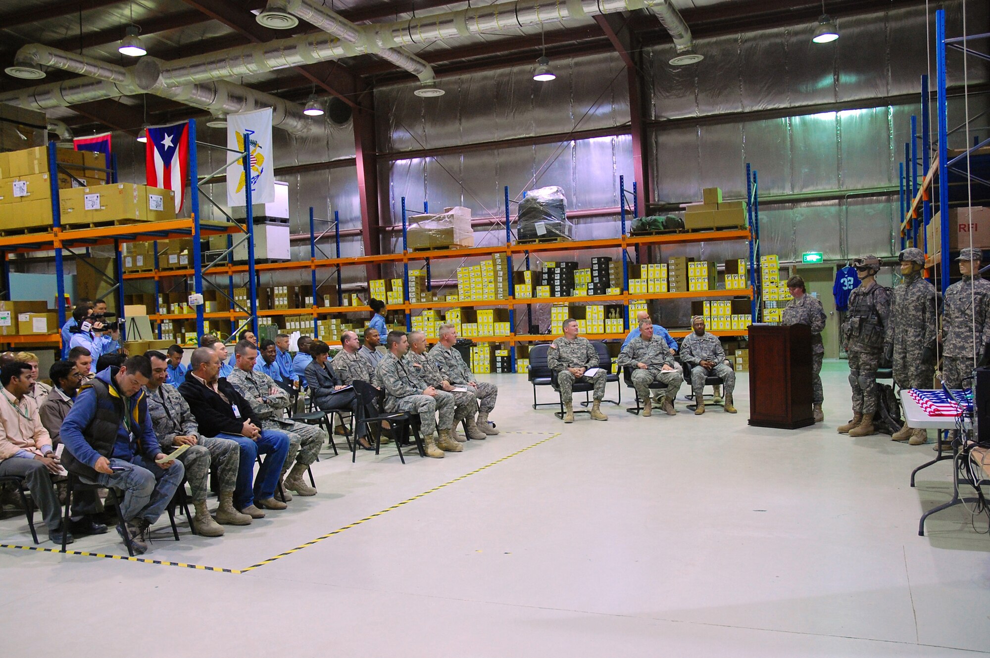 SOUTHWEST ASIA -- Army Maj. Renel Hall-Beck, operations officer in charge of the Rapid Fielding Initiative outside of the continental United States, speaks Jan. 28, 2008, during a dedication and ribbon-cutting ceremony for the RFI's facility flag display building at a Life Support Area in the Persian Gulf Region. The flags are being hung to pay tribute to the more than the 2,000 soldiers who pass through the RFI's LSA facility each month before boarding flights for Iraq and Afghanistan. (U.S. Air Force photo/ Senior Airman Patrick Dixon)