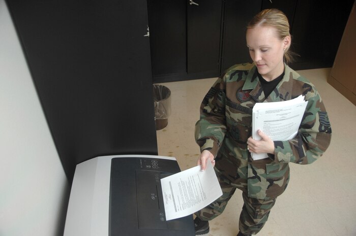 NELLIS AIR FORCE BASE, Nev.—Tech. Sgt. Angela Schlosser, an Airman Leadership School instructor temporarily assigned to Nellis’ ALS from the12th Mission Support Squadron, Randolph AFB, Texas, shreds old ALS curriculum here Jan. 28. The new course material, which was sent out Air Force wide, was implemented this month. (U.S. Air Force photo by Staff Sgt. Scottie T. McCord)