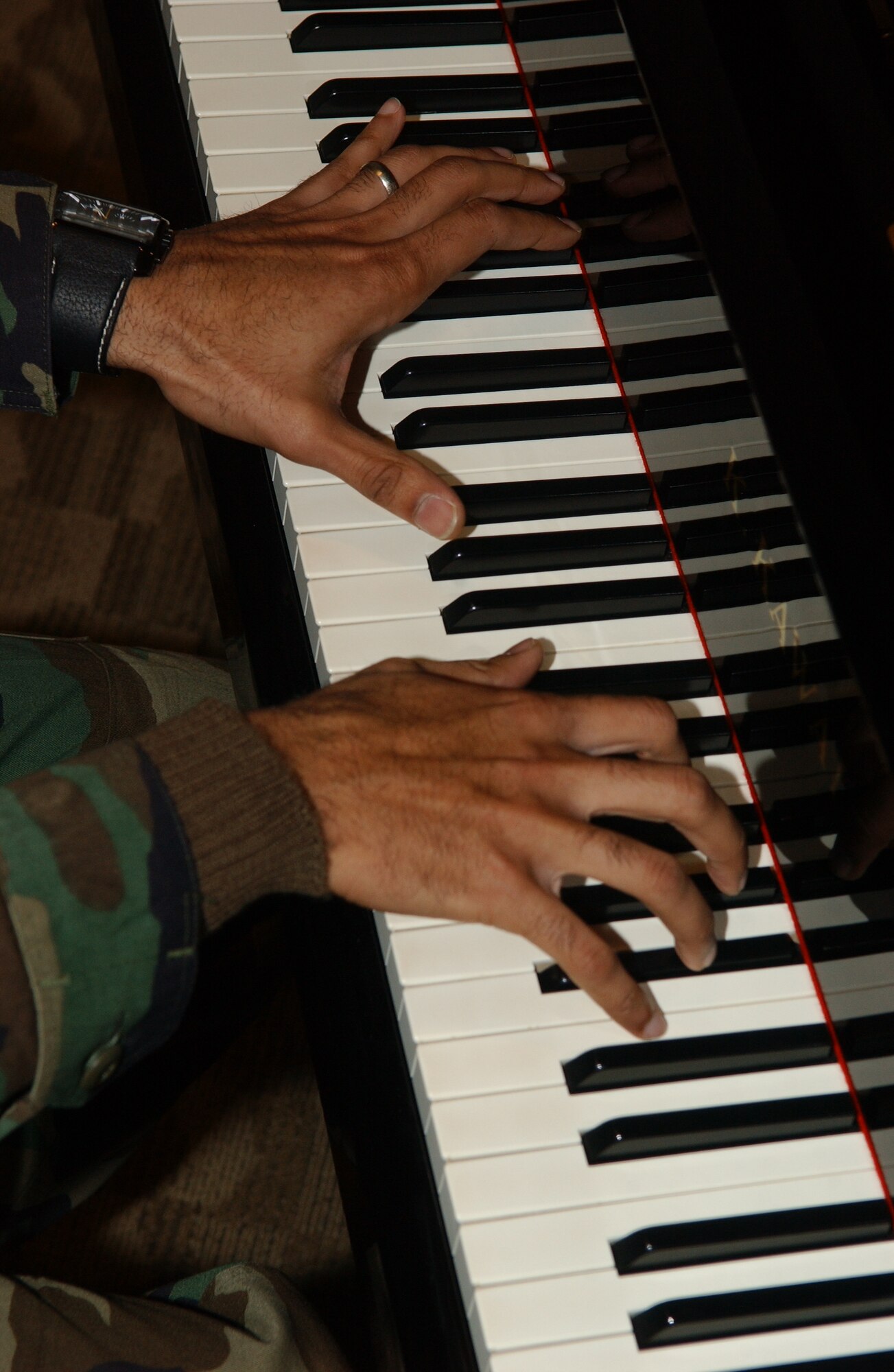 MISAWA AIR BASE, Japan -- Tech. Sgt. Lamon Mabron, 35th Logistics Readiness Squadron, lets his fingers dance over the keys of the piano in the Mokuteki Community Center Jan. 18. After seeing a poster in the Mokuteki, Sergeant Mabron auditioned and was selected for Tops in Blue. (U.S. Air Force photo by Senior Airman Robert Barnett)