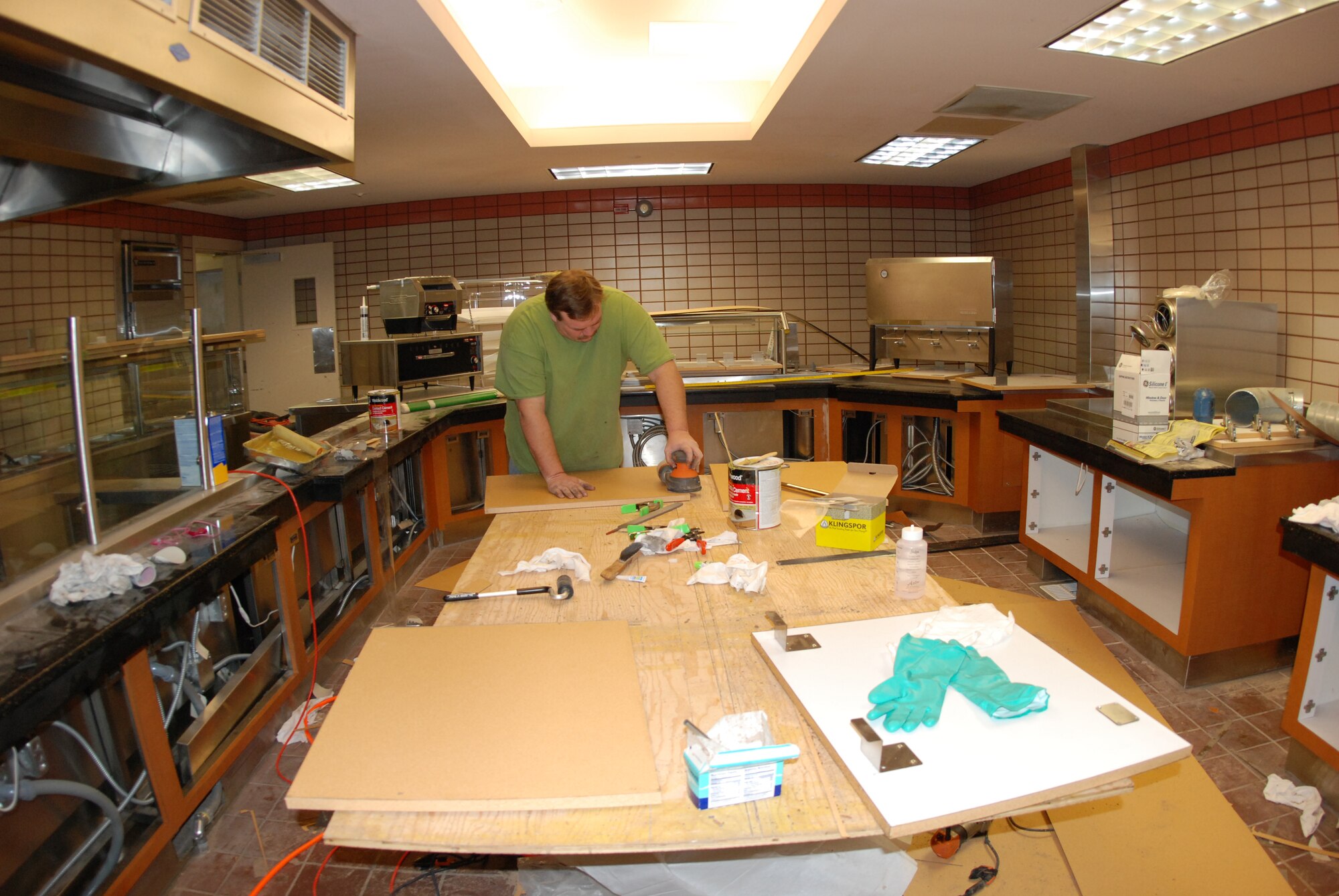 EIELSON AIR FORCE BASE, Alaska--Jeremy Stevens, American Food Service craftsman, measures, cuts and sands material to construct laminates for the newly-designed Two Seasons Dining Facility Jan. 29. The DFAC is scheduled to open Feb. 5 after a 10-week renovation period in which a new serving area, new tables, kitchen equipment upgrades and a new dishwashing machine were installed. The design of the new facility is aimed at serving [RED FLAG-Alaska] guests more efficiently.  (U.S. Air Force photo by Airman 1st Class Nora Anton)

