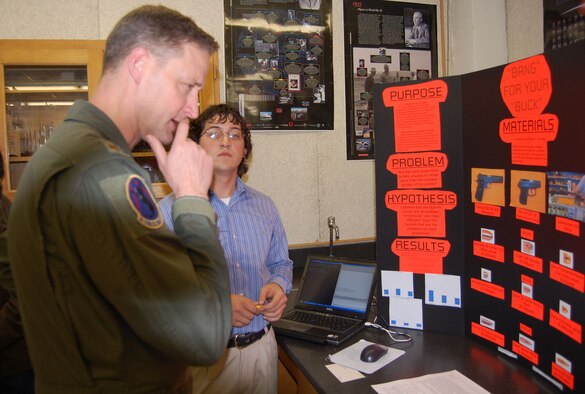 Maj. Robert Frink, 84th Flying Training Squadron, observes as a Del Rio High School student describes how his experiment shows whether or not expensive bullets are more efficient than their cheaper counterparts during the school’s science fair Jan. 24. More than ten Laughlin members from various squadrons volunteered to judge the school’s annual science fair. (U.S. Air Force photo by Senior Airman Olufemi Owolabi)

