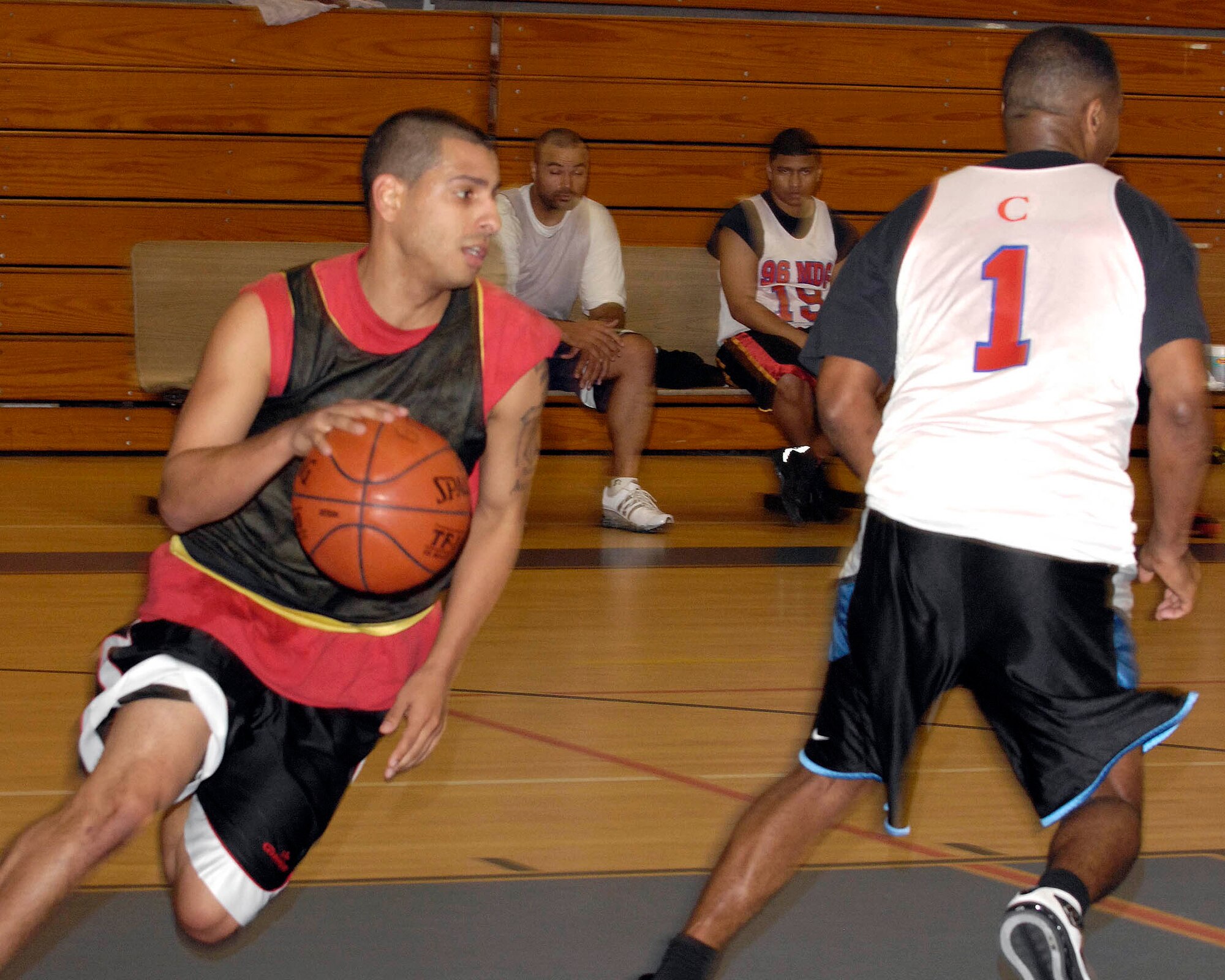 EGLIN AIR FORCE BASE, Fla. -- Erick Andujar, a guard for 96 COMM, dribbles past Ramoane Jordan, small forward for 96 MDG, during the 2007 Intramural Basketball Championship Jan. 28 here. The 96 COMM team emerged victorious, 53-48. (Photo by Greg Murray)