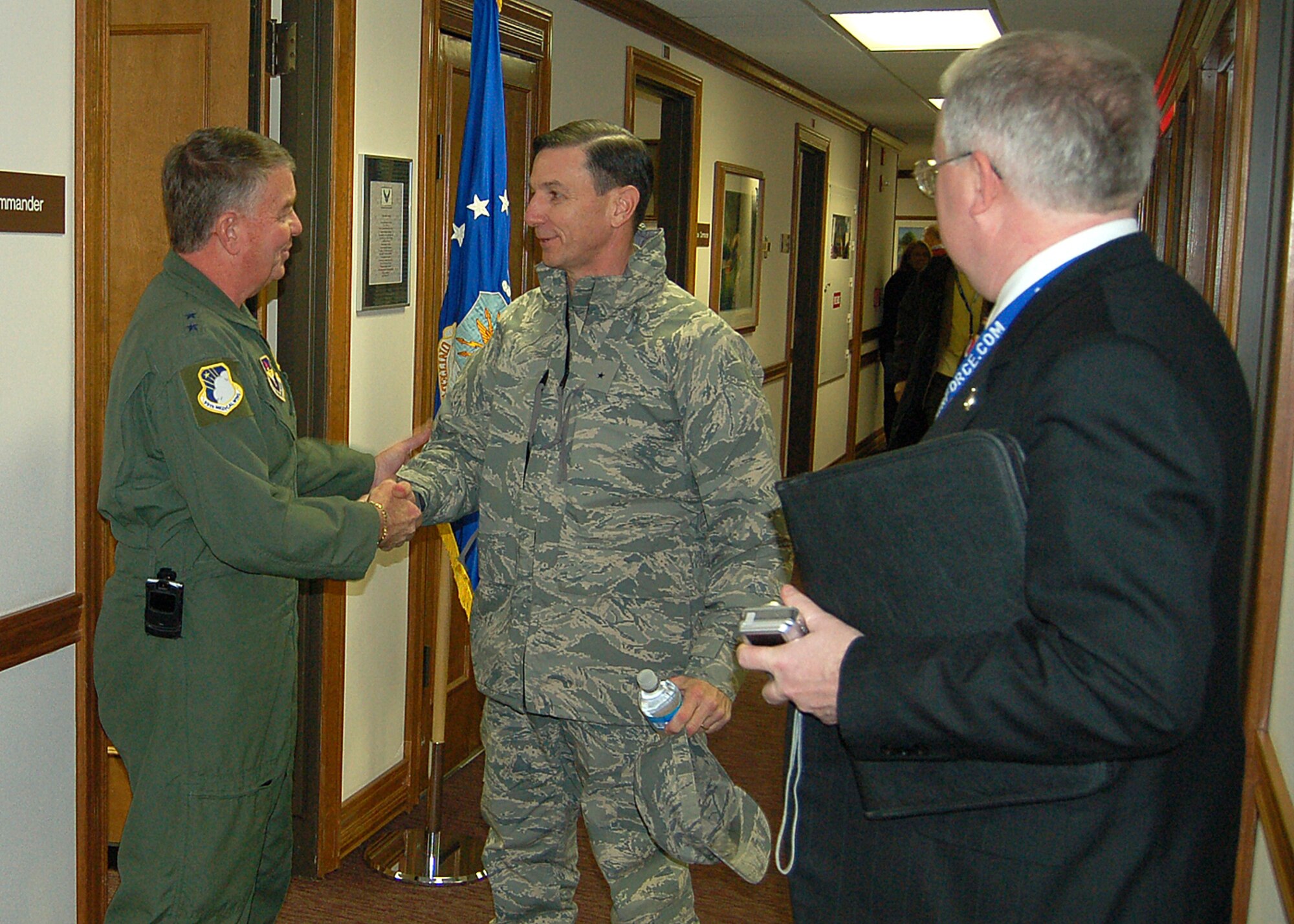 59th Medical Wing Commander, Maj. Gen. Tom Travis  (left) greets Air Mobility Command Surgeon General, Brig. Gen. (Dr.) Byron Hepburn and members of the Chicago medical professionals Jan. 23 during a National Civic Outreach tour at Wilford Hall Medical Center.  High-level medical leaders were educated on the capabilities of the Department of Defense's enroute care system, which is providing historically successful care to those wounded or injured in the current war.  (U.S. Air Force photo by Staff Sgt. Ruth Stanley)
