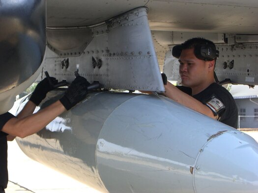 KORAT ROYAL THAI AIR BASE, Thailand -- Senior Airman Paul Tamura downloads travel pods from an A-10 after its arrival here Jan. 27. Six A-10s from the 25th Fighter Squadron arrived here from Osan Air Base, South Korea to participate in Exercise Cope Tiger 2008. Airman Tamura is a weapons load crew member in the 51st Aircraft Maintenance Squadron of the 51st Fighter Wing, Osan. Cope Tiger is a multilateral joint and combined field training and humanitarian and civic assistance exercise involving Thailand, Singapore and the United States. The Thai-, Singaporean- and U.S.-hosted exercise enhances combined readiness and interoperability, reinforces U.S. commitment to the Southeast Asian region, and demonstrates U.S. capability to project combined and joint forces strategically in a multilateral environment. (U.S. Air Force photo by Capt. Renee Lee).