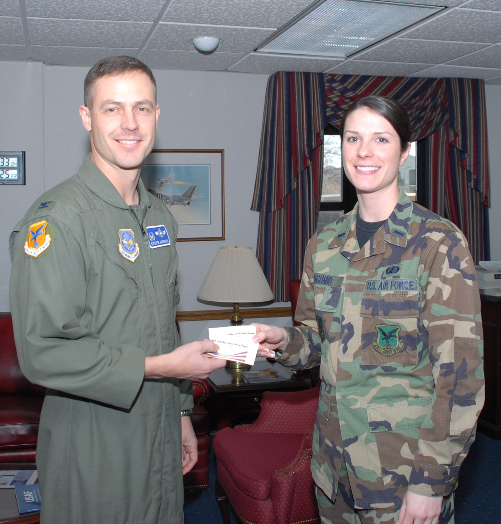Col. Steven Harrison, 436th Airlift Wing commander, purchased a ticket for the 2007 Dover Air Force Base Annual Awards Banquet from 1st Lt. Megan Schmid, 436th AW executive officer, Jan. 25. The colonel was Team Dover's first Airman to purchase a ticket for the Feb. 20 event, which will feature Retired Chief Master Sgt. of the Air Force Robert Gaylor, the fifth chief master sergeant of the Air Force, as a guest speaker. (U.S. Air Force photo/Tech. Sgt. Kevin Wallace)