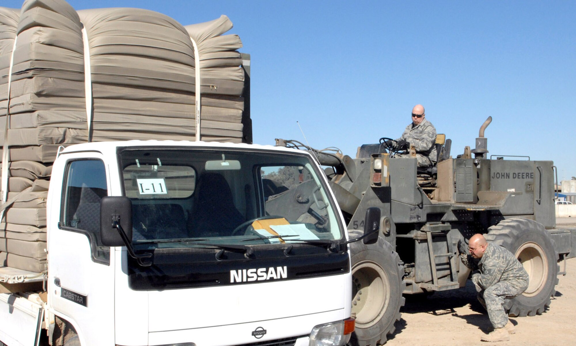 Tech. Sgts. James Killingsworth and Victor Rivera, reservists and aerial porters with the 506th Expeditionary Logistics Readiness Squadron, help load supplies for the Iraqi military recently. The aerial port here comprises 25 Airmen, all from the 35th Aerial Port Squadron, McGuire Air Force Base, N.J. For the first time, Kirkuk’s aerial port function is now run exclusively by reservists without active-duty assistance. (U.S. Air Force photo by Senior Airman SerMae Lampkin)