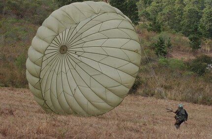 SOTO CANO AIR BASE, Honduras – The wind pushes a Honduran soldier’s chute after he lands safely from his first leap from an Army UH-60, the airborne platform used Honduran Army airborne readiness training.  More than 250 Honduran soldiers took their first step leap from the back of a helicopter Jan. 24 in a combined jump with U.S. Soldiers here.. (U.S. Air Force photo by Martin Chahin)