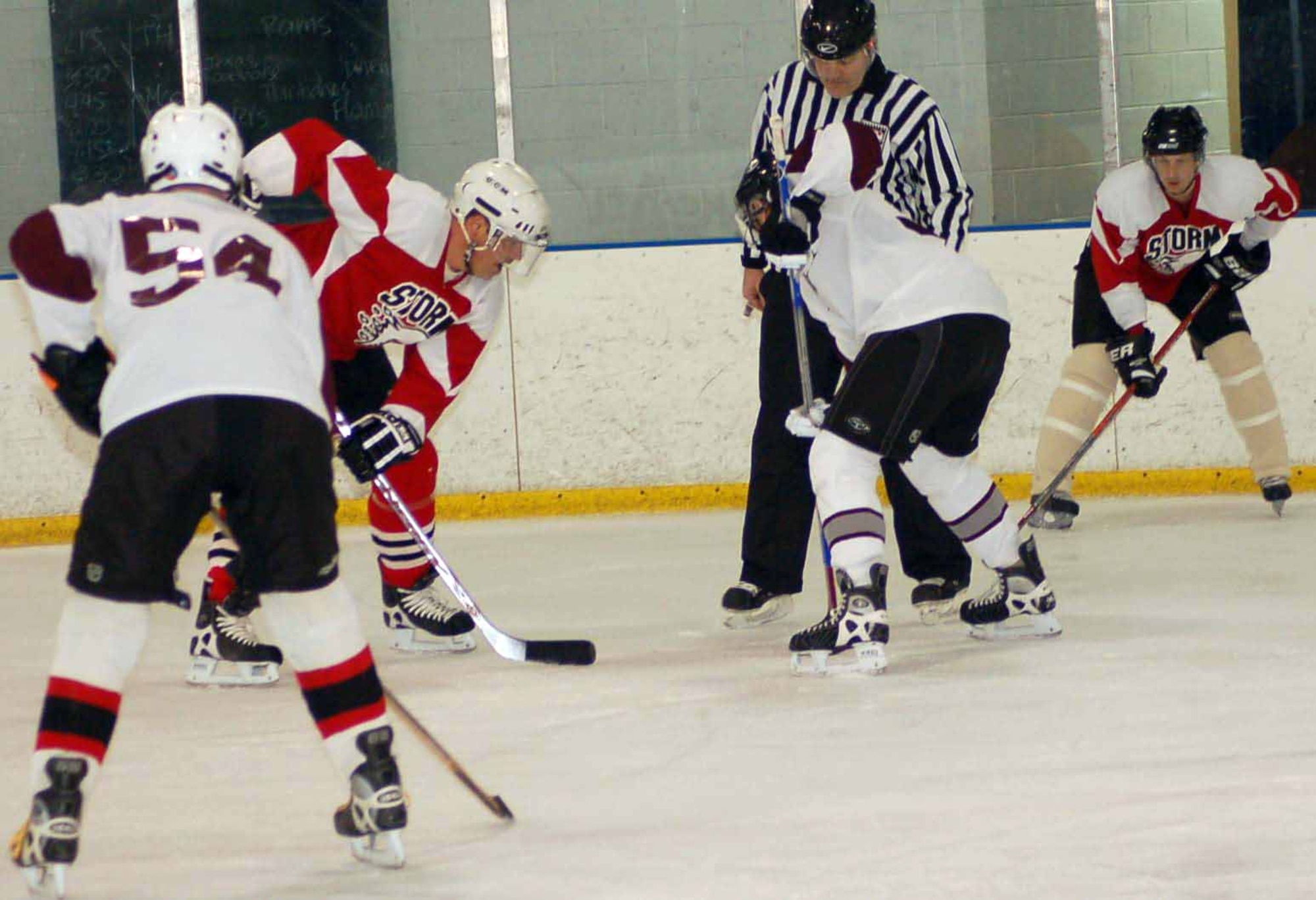 Hawks forward Luke Hadsall stands in the face off circle while Andy Spivey (54) waits for the puck drop during the second period against The Storm Jan. 27 at the Arctic Edge Ice Arena in Edmond. The Hawks won 4-1.  (Air Force photo by John E. Banks