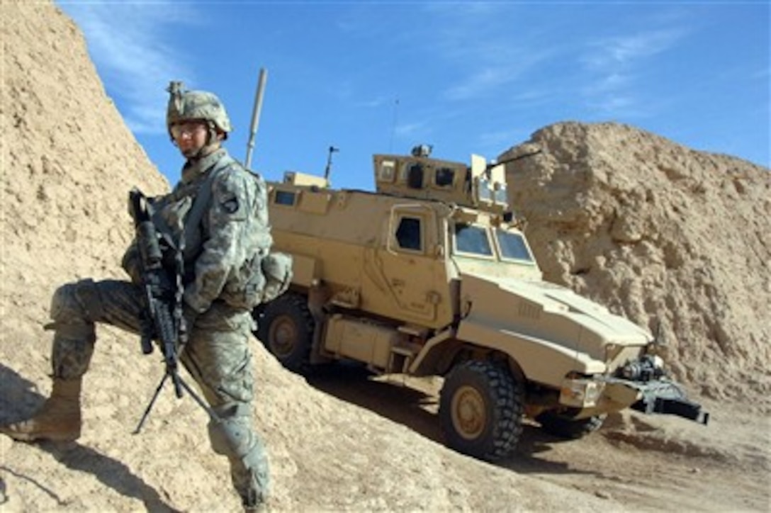 U.S. Army Pfc. John Courson pauses at a breech in a berm as he takes part in a patrol in Samarah, Iraq, on Jan. 18, 2008.  Courson is attached to Charlie Company, 2nd Battalion, 1st Brigade, 101st Airborne Division.  