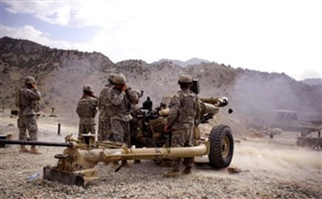 Airborne artillery men from 82nd Airborne Division, 321st Airborne Field Artillery Regiment,  2nd Battalion, hold their ears while firing a 105 millimeter howitzer at Firebase Wilderness in Paktya Province, Afghanistan, Jan. 28, 2008. 