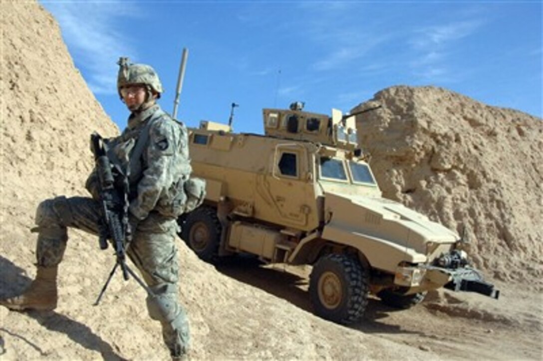 U.S. Army Pfc. John Courson pauses at a breech in a berm as he takes part in a patrol in Samarah, Iraq, on Jan. 18, 2008.  Courson is attached to Charlie Company, 2nd Battalion, 1st Brigade, 101st Airborne Division.  