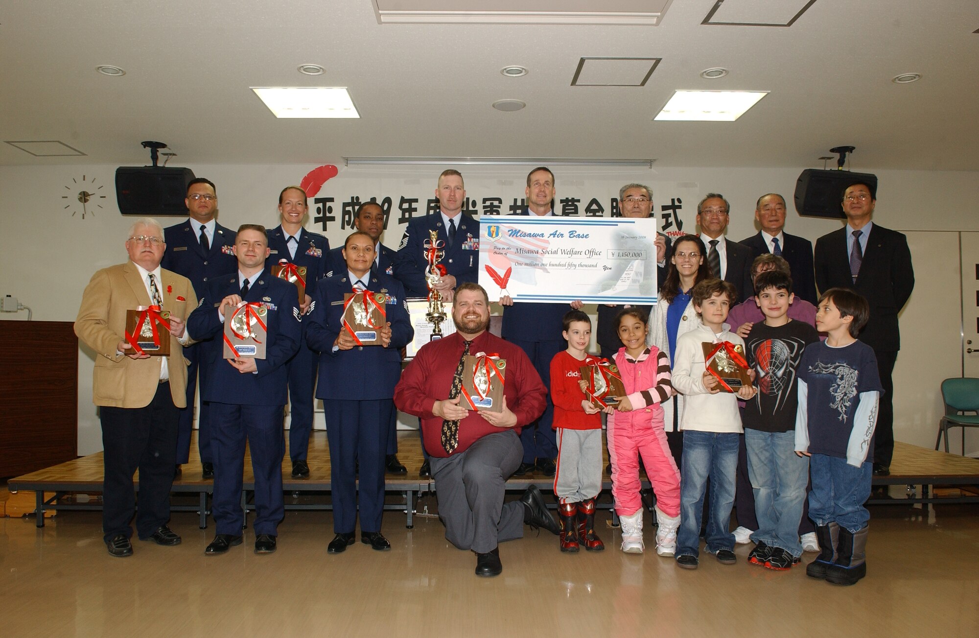 MISAWA AIR BASE, Japan -- Col. T.J. O'Shaughnessy, 35th Fighter Wing commander, poses with representatives from Misawa Air Base and the Misawa community, celebrating their contributions to the Red Feather Campaign during the wrap-up ceremony at the Misawa Community Center Jan. 18, 2008. The Red Feather Campaign is the only non-U.S. organization with privileges to raise funds on base. (U.S. Air Force photo by Senior Airman Robert Barnett)