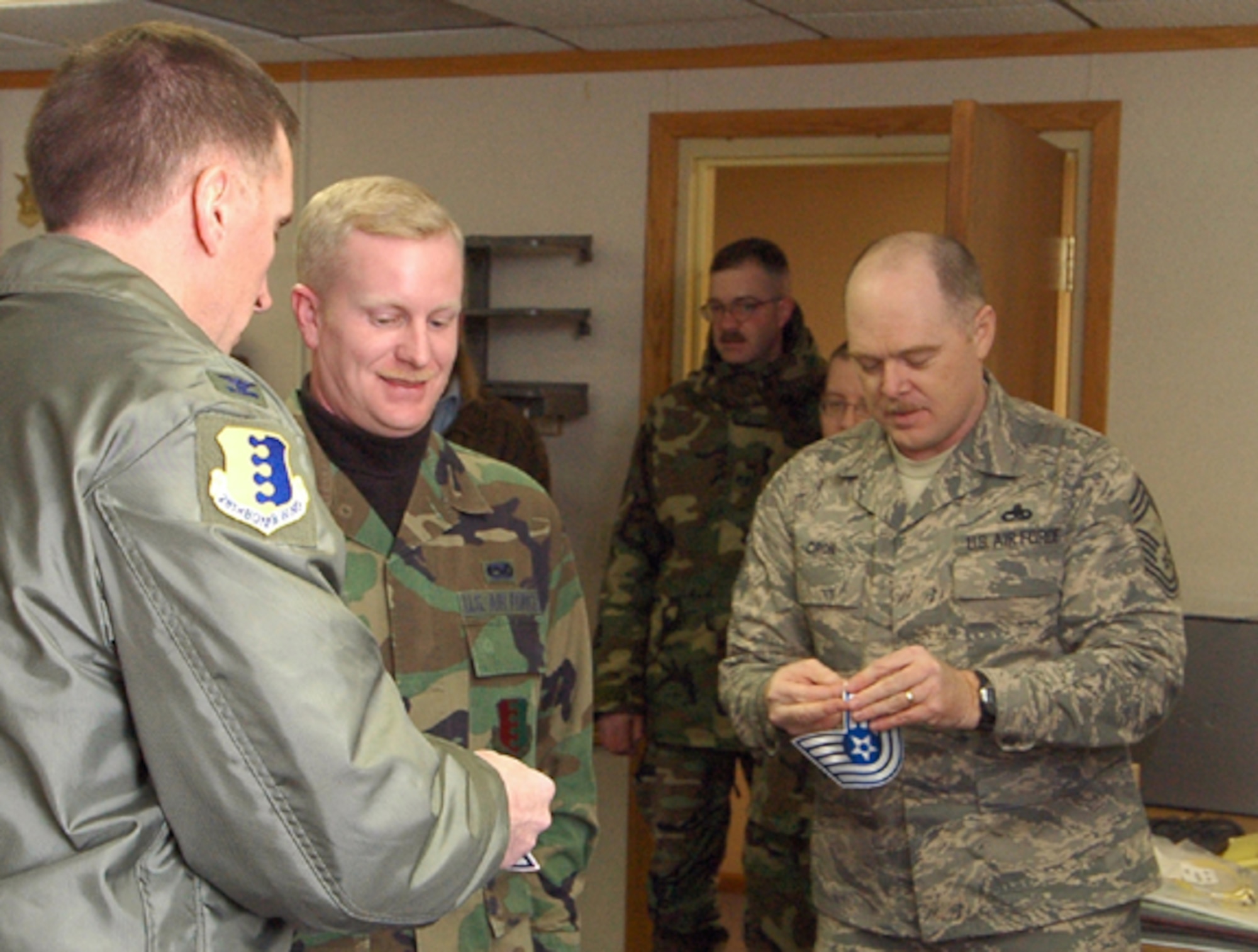 Tech. Sgt. Richard Trimble, 28th Communications Squadron network infrastructure supervisor, is promoted to the rank of technical sergeant through the Stripes for Exceptional Performers program, Jan. 29. Col. Scott Vander Hamm, 28th Bomb Wing commander, and Chief Master Sgt. Stephen Cron, 28th Communications Squadron, prepare to tack on Sergeant Trimble's new stripes.  Sergeant Trimble greatly exceeded the standards as a staff sergeant, earning the immediate promotion, which is given out to only a few Airman nominated for the STEP program throughout the wing.
