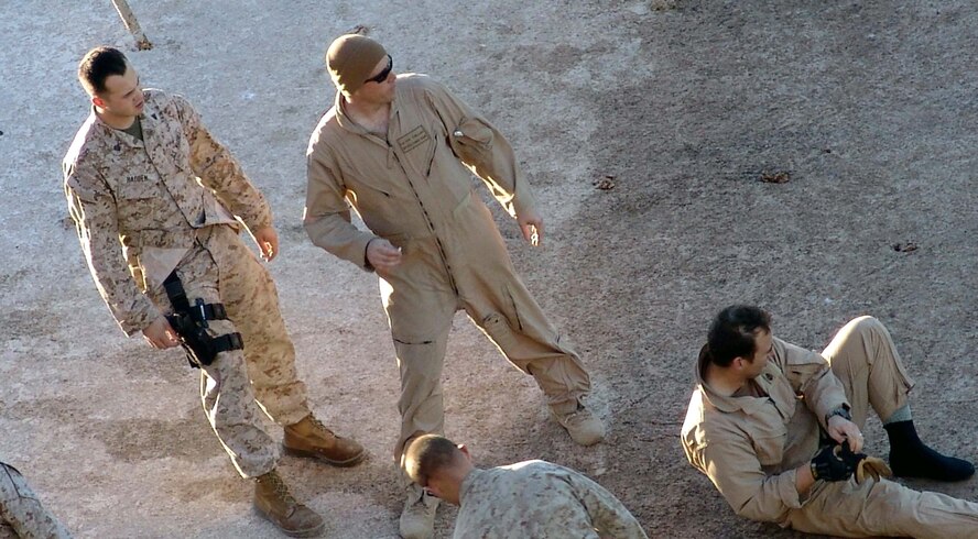 Air Force Office of Special Investigations Special Agent James Collins, (middle) looks on after assisting with the rescue of 10 passengers from a C-46 Sea Knight helicopter that crash landed in a lake in Iraq, Dec. 3, 2006. (U.S. Air Force photo)