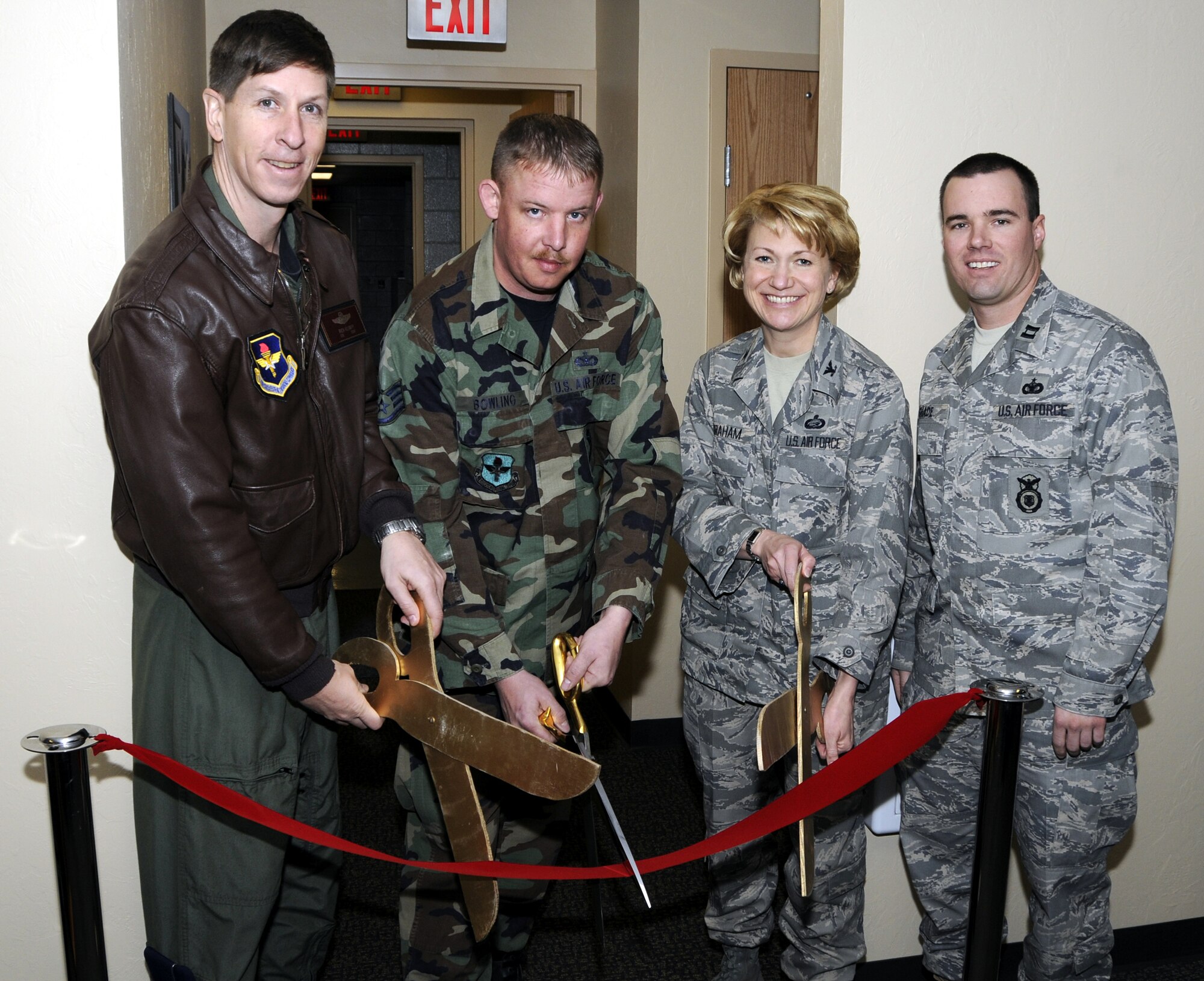 Col. Richard Klumpp Jr., 71st Flying Training Wing commander, Staff Sgt. Matthew Bowling, military working dog kennel master, Col. Jennifer Graham, 71st Mission Support Group commander and Capt. Brandon Shade, acting 71st Security Forces Squadron commander, celebrate the opening of the newly constructed military working dog facility Jan. 29. The facility features  six kennels, up from four, a larger outside training area, a veterinary room, additional storage and office space.
(U.S. Air Force photo by Terry Wasson)