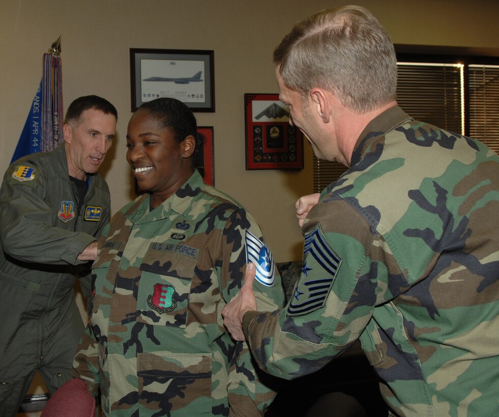 Tech. Sgt. Shanda De Anda, 28th Bomb Wing Public Affairs assistant NCO in
charge, is promoted to the rank of technical sergeant through the Stripes
for Exceptional Performers program, Jan. 28. Col. Scott Vander Hamm, 28th
Bomb Wing commander, and Chief Master Sgt. John Gillette, 28th Bomb Wing command chief, tack on Sergeant De Anda's new stripes. Sergeant De Anda greatly
exceeded the standards as a staff sergeant, earning the immediate promotion, which is given out to only a few Airman nominated for the STEP program throughout the wing.
