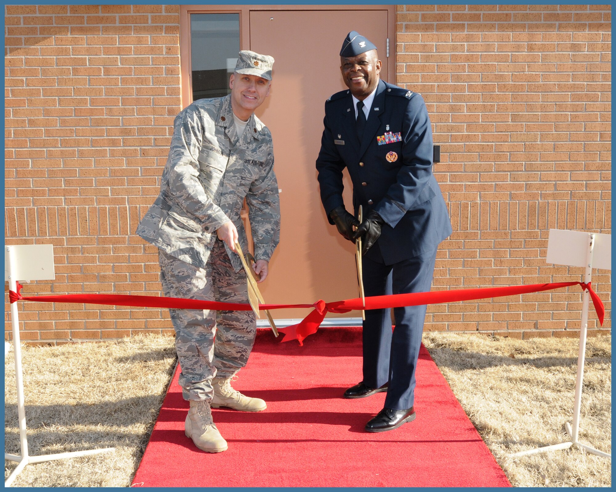 Maj.  Ronald Johnson, chief of Mental Health services and Col. Otha Solomon Jr., 71st Medical Group commander cut a ribbon to open Vance Air Force Base''s new mental health faciility Jan. 22. (U.S. Air Force photo by Terry Wasson)