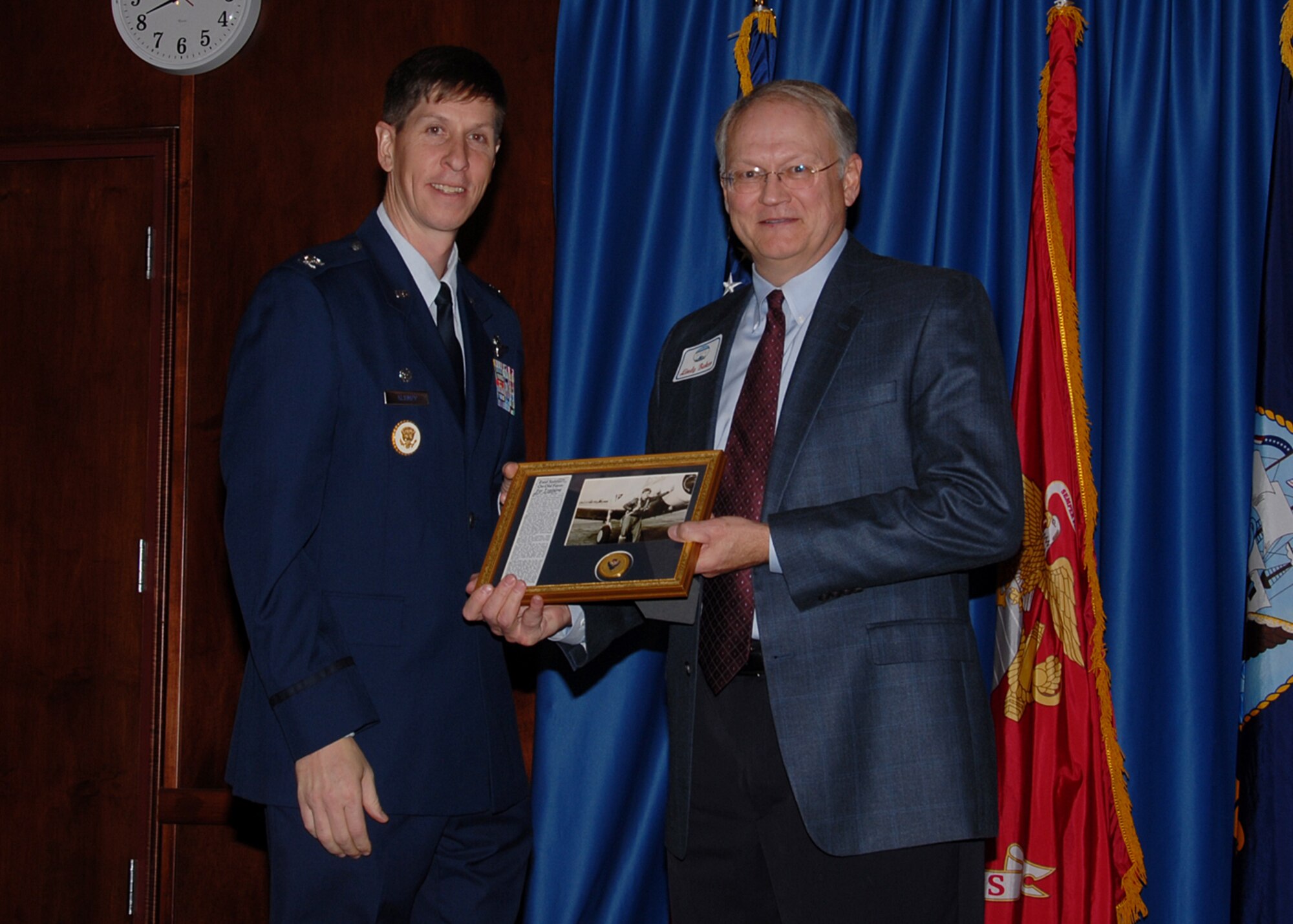 Col. Richard Klumpp, Jr. presents Lindy Baker, 1st Lt. Ralph Baker's son and the 71st Logistics Readiness Squadron’s 2007 honorary commander, a commemorative plaque of his father at the 2008 Honorary Commander’s Hail & Farewell dinner Jan. 25. Colonel Klumpp announced at the event that the new Vance industrial gate will be renamed the Baker Gate, in honor of Ralph Baker’s ties to Vance and the Enid community.