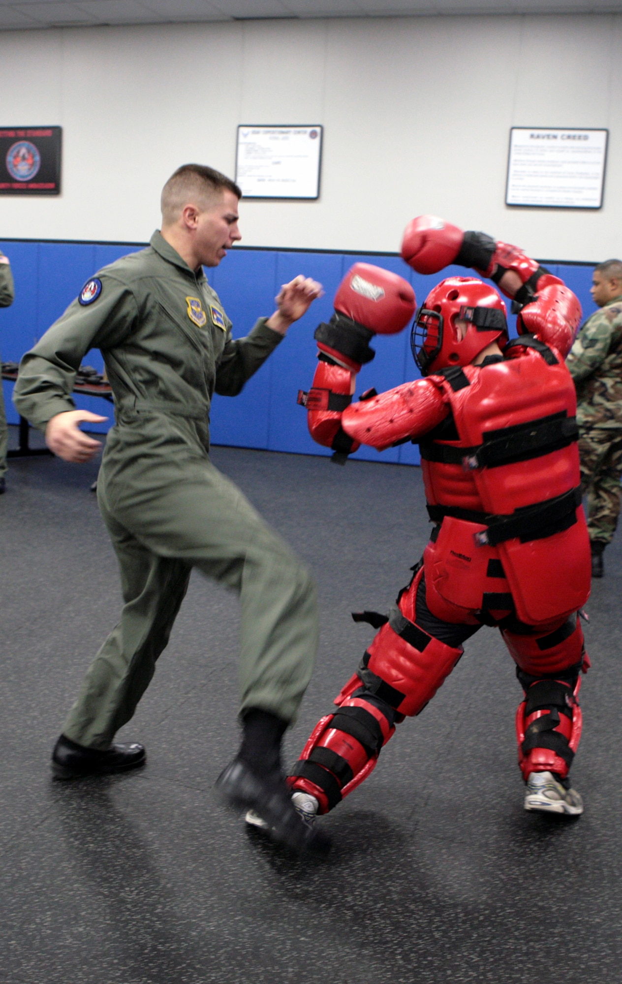 Staff Sgts. James Chubb and Brian Arrington (in red suit), both Phoenix Raven instructors from the U.S. Air Force Expeditionary Center's 421st Combat Training Squadron, participate in a Raven demonstration Jan. 22 in the Center at Fort Dix, N.J.  Raven training is done annually by the 421st CTS preparing security forces Airmen for aircraft security missions at home and abroad.  (U.S. Air Force Photo/Master Sgt. Bob Lorusso)