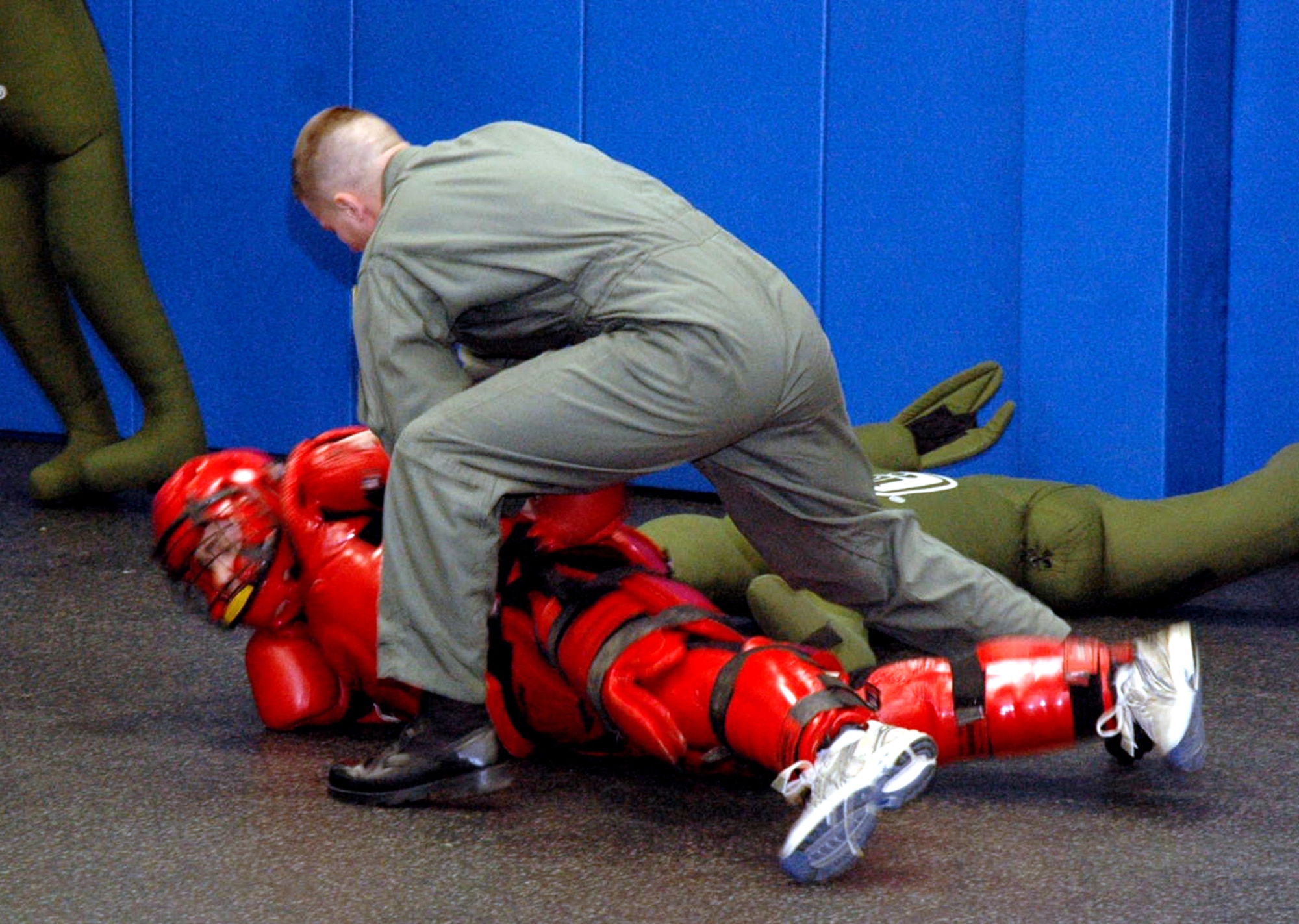Staff Sgts. Brian Arrington (in red suit) and ames Chubb, both Phoenix Raven instructors from the U.S. Air Force Expeditionary Center's 421st Combat Training Squadron, participate in a Raven demonstration Jan. 22 in the Center at Fort Dix, N.J.  Raven training is done annually by the 421st CTS preparing security forces Airmen for aircraft security missions at home and abroad.  (U.S. Air Force Photo/Tech. Sgt. Scott T. Sturkol)