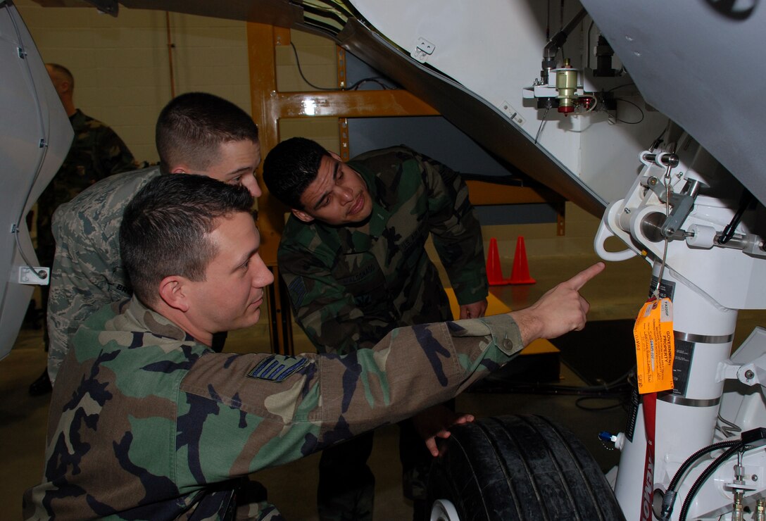 Staff Sgt. Dustin Garcia, a F-22 Raptor crew chief course instructor with the 362nd Training Squadron shows Airman James Brouillard, an Airmen in Training in the F-22 Raptor crew chief course, and Staff Sgt. Abiasaph Maldonado Jr., a student in the Raptor crew chief course a Raptor fuselage trainer Jan. 29. Sergeant Maldonado and Airmen Brouillard are two of the first Airmen to attend training in the new Raptor Maintenace Training Facility. (U.S. Air Force photo/Airman 1st Class Jacob Corbin)