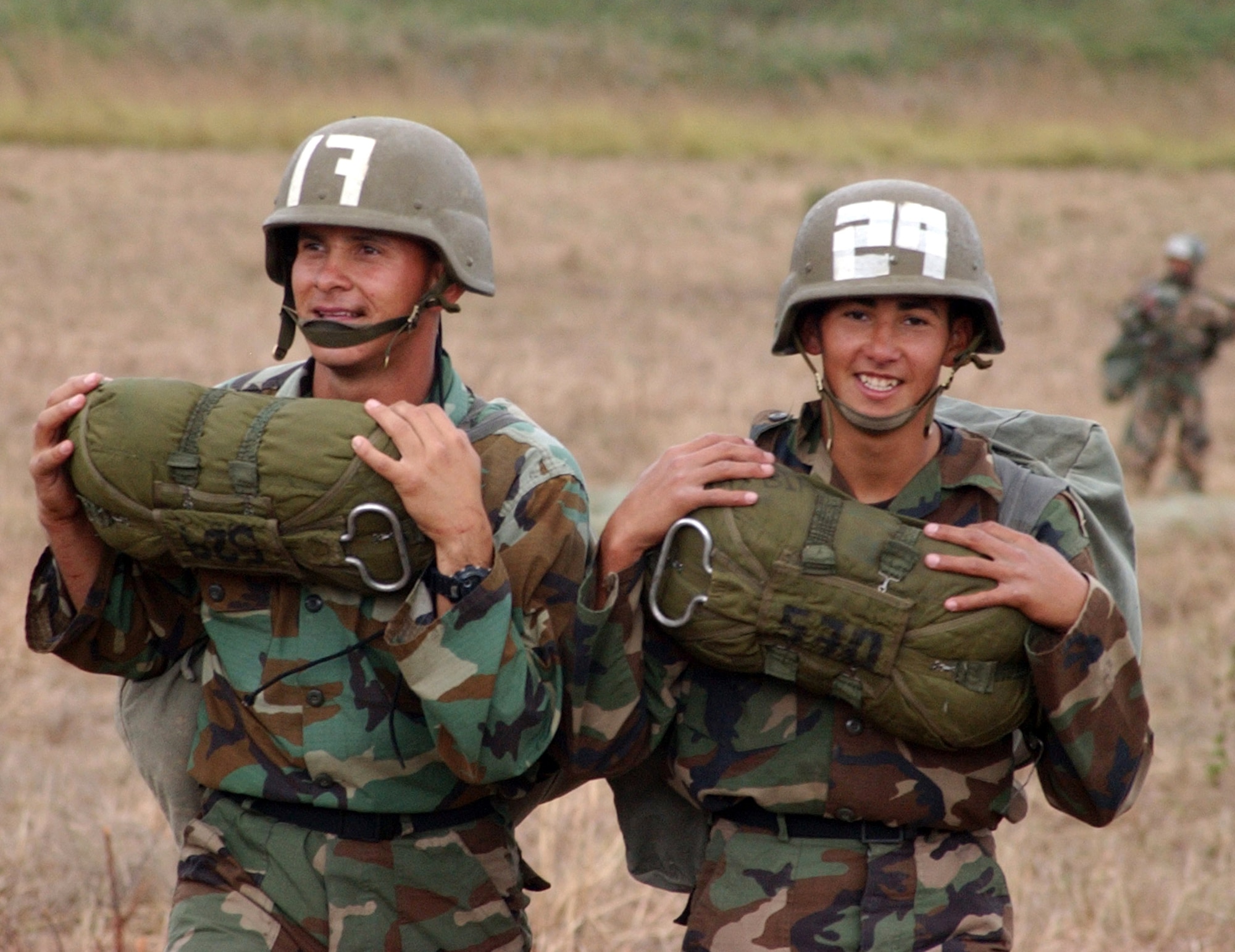 Honduran soldiers beam with pride after taking their first jump from the back of an Army CH-47D helicopter. More than 250 Honduran soldiers took their first step toward Airborne readiness when they leaped from the back of the helicopter Jan. 24 in a combined jump with U.S. Soldiers in Tamara, Honduras. (U.S. Air Force photo/Martin Chahin)