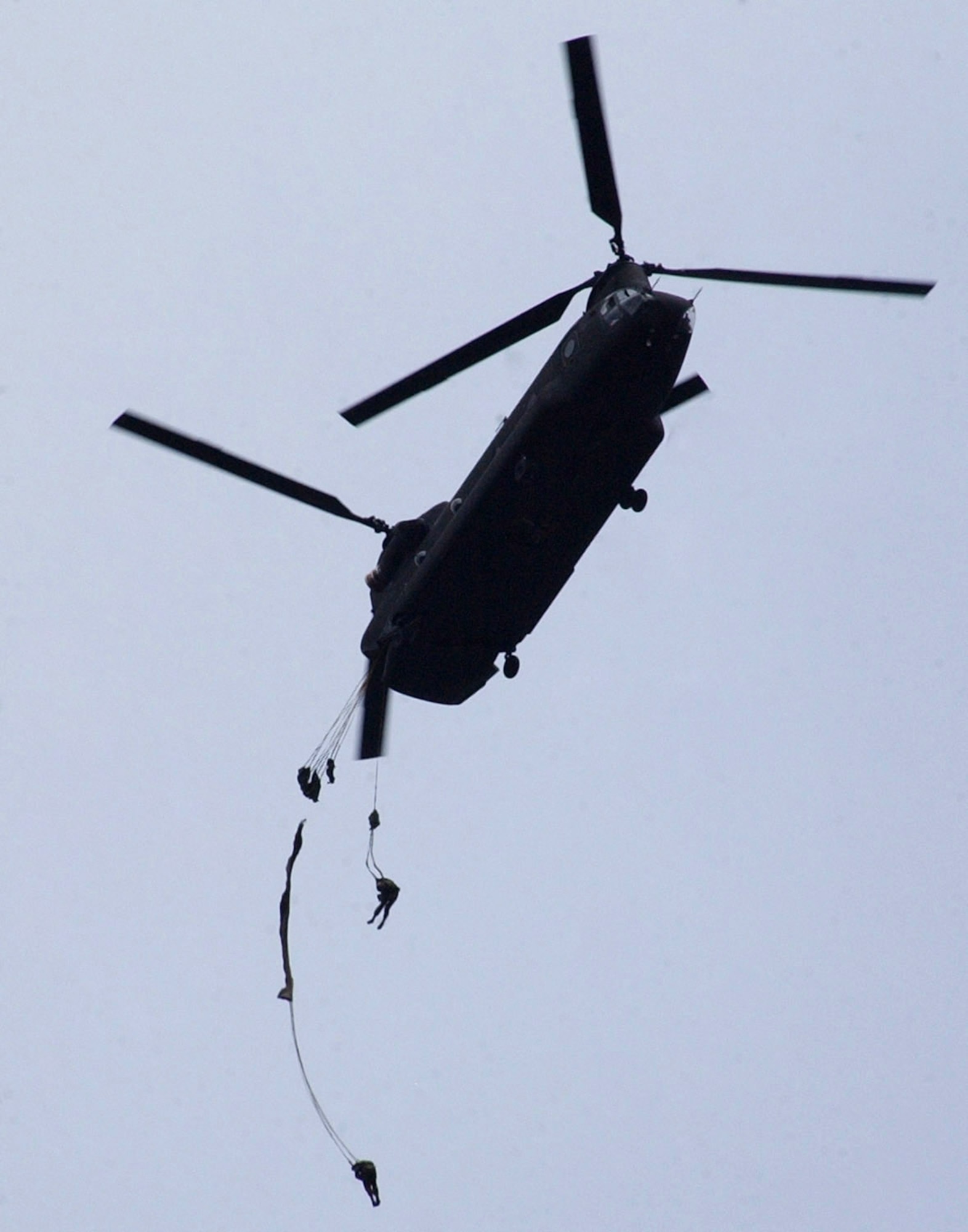 Honduran soldiers descend from the back of an Army CH-47D helicopter Jan. 24 at the Honduran airborne troop headquarters at Tamara, Honduras. More than 250 Honduran soldiers took their first step toward Airborne readiness when they leaped from the back of the helicopter in a combined jump with U.S. Soldiers. (U.S. Air Force photo/Martin Chahin) 