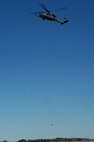 MOODY AIR FORCE BASE, Ga. -- An HH-60G Pave Hawk hovers while hoisting up a 600-pound weight during a hoist weight check Jan. 30 here. These checks are conducted when new lines are installed. (U.S. Air Force photo by Airman 1st Class Gina Chiaverotti)