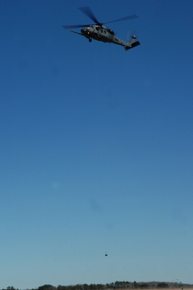 MOODY AIR FORCE BASE, Ga. -- An HH-60G Pave Hawk hovers while hoisting up a 600-pound weight during a hoist weight check Jan. 30 here. These checks are conducted when new lines are installed. (U.S. Air Force photo by Airman 1st Class Gina Chiaverotti)