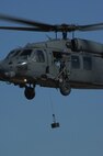 MOODY AIR FORCE BASE, Ga. -- An HH-60G Pave Hawk hovers while hoisting up a 600-pound weight during a hoist weight check Jan. 30 here. The check is performed after a new line is installed to make sure there are no discrepancies. (U.S. Air Force photo by Airman 1st Class Gina Chiaverotti)