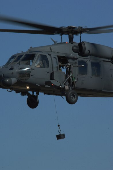 MOODY AIR FORCE BASE, Ga. -- An HH-60G Pave Hawk hovers while hoisting up a 600-pound weight during a hoist weight check Jan. 30 here. The check is performed after a new line is installed to make sure there are no discrepancies. (U.S. Air Force photo by Airman 1st Class Gina Chiaverotti)