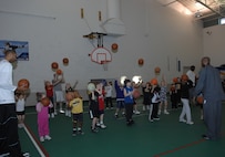 MINOT AIR FORCE BASE, N.D. -- Minot Skyrockets center Lee Scruggs and forward Kevin Rice help children develop their shooting form at the David C. Jones Youth Center here Jan. 26. The Skyrockets held a free basketball camp for youth, ages 5-18. (U.S. Air Force photo by Airman 1st Class Sharida Bishop)