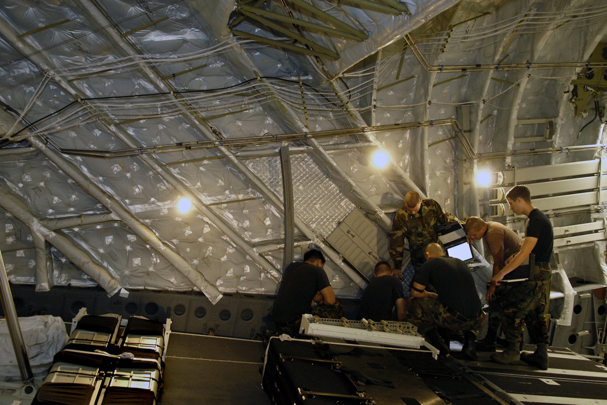 HICKAM AIR FORCE BASE, Hawaii -- Crewchiefs work on a C-17 Globemaster III Jan. 22, 2008 at Hickam Air Force Base, Hawaii. The maintainers, from the combined aircraft maintenance squadron of active duty and Hawaii Air National Guard personnel, are conducting a maintenance orientation for newly assigned Airmen. On Jan. 16, the vice chief of staff of the Air Force presented Pacific Air Forces with the Gen. Wilbur L. Creech Maintenance Excellence award which honors the major command demonstrating the most improved performance in aircraft maintenance and logistics readiness. (U.S. Air Force photo/Tech. Sgt. Shane A. Cuomo) 
