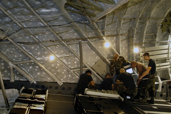 HICKAM AIR FORCE BASE, Hawaii -- Crewchiefs work on a C-17 Globemaster III Jan. 22, 2008 at Hickam Air Force Base, Hawaii. The maintainers, from the combined aircraft maintenance squadron of active duty and Hawaii Air National Guard personnel, are conducting a maintenance orientation for newly assigned Airmen. On Jan. 16, the vice chief of staff of the Air Force presented Pacific Air Forces with the Gen. Wilbur L. Creech Maintenance Excellence award which honors the major command demonstrating the most improved performance in aircraft maintenance and logistics readiness. (U.S. Air Force photo/Tech. Sgt. Shane A. Cuomo) 
