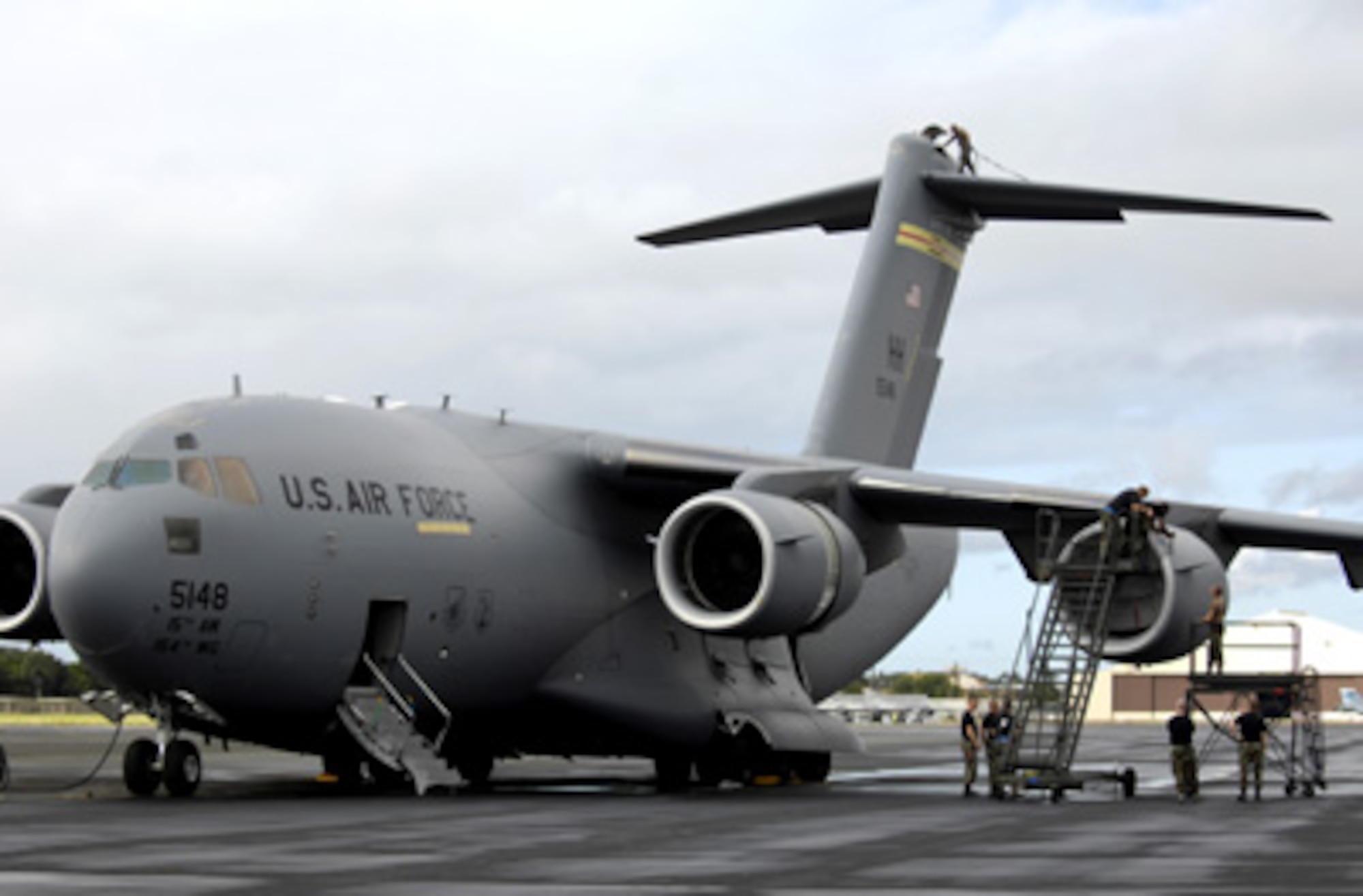 HICKAM AIR FORCE BASE, Hawaii -- Crewchiefs work on a C-17 Globemaster III Jan. 22, 2008 at Hickam Air Force Base, Hawaii. The maintainers, from the combined aircraft maintenance squadron of active duty and Hawaii Air National Guard personnel, are conducting a maintenance orientation for newly assigned Airmen. On Jan. 16, the vice chief of staff of the Air Force presented Pacific Air Forces with the Gen. Wilbur L. Creech Maintenance Excellence award which honors the major command demonstrating the most improved performance in aircraft maintenance and logistics readiness. (U.S. Air Force photo/Tech. Sgt. Shane A. Cuomo) 
