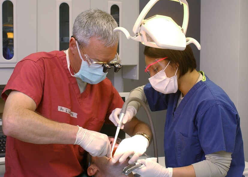 Col. James Lindemuth, 60th Dental Squadron dentist, and Staff Sgt. Tanya Hazen, 60th DS dental technician, perform a tooth extraction on a Soldier at the Task Force Medical facility at Bagram Air Base, Afghanistan Jan. 20. (U.S. Air Force photo/Master Sgt. Demetrius Lester)  
