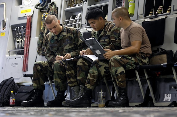 HICKAM AIR FORCE BASE, Hawaii -- Crewchiefs go over their maintenance forms on a C-17 Globemaster III Jan. 22, 2008 at Hickam Air Force Base, Hawaii. The maintainers, from the combined aircraft maintenance squadron of active duty and Hawaii Air National Guard personnel, are conducting a maintenance orientation for newly assigned Airmen. On Jan. 16, the vice chief of staff of the Air Force presented Pacific Air Forces with the Gen. Wilbur L. Creech Maintenance Excellence award which honors the major command demonstrating the most improved performance in aircraft maintenance and logistics readiness. (U.S. Air Force photo/Tech. Sgt. Shane A. Cuomo) 
