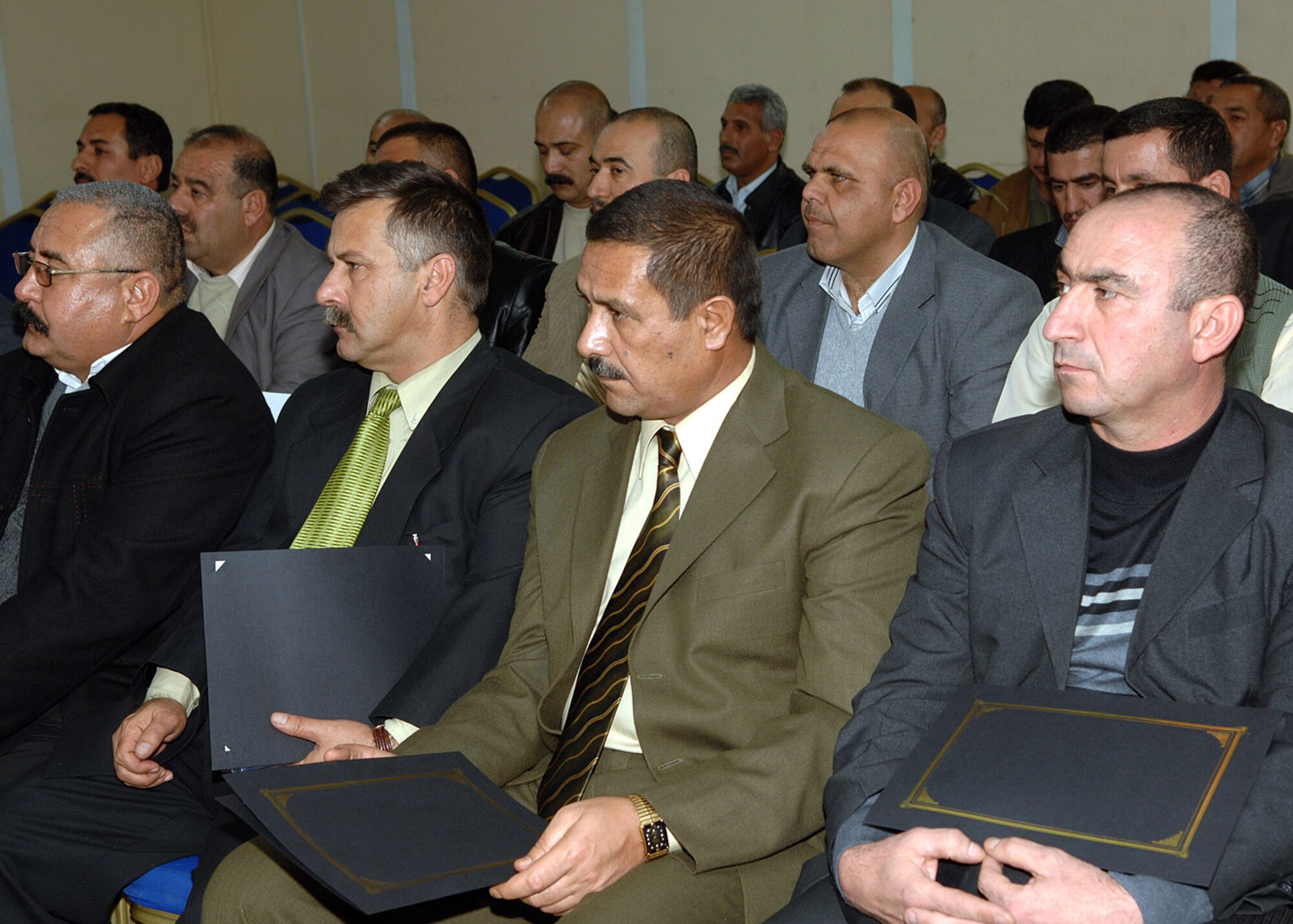 Recent graduates of the Senior Law Enforcement Staff Management course receive certificates during a recent ceremony marking their accomplishment. The course's curriculum incorportated classroom and field exercises, and specific lessons included human resources management, morale building, decision making, logistics and use of force. (U.S. Air Force photo by Senior Airman SerMae Lampkin)