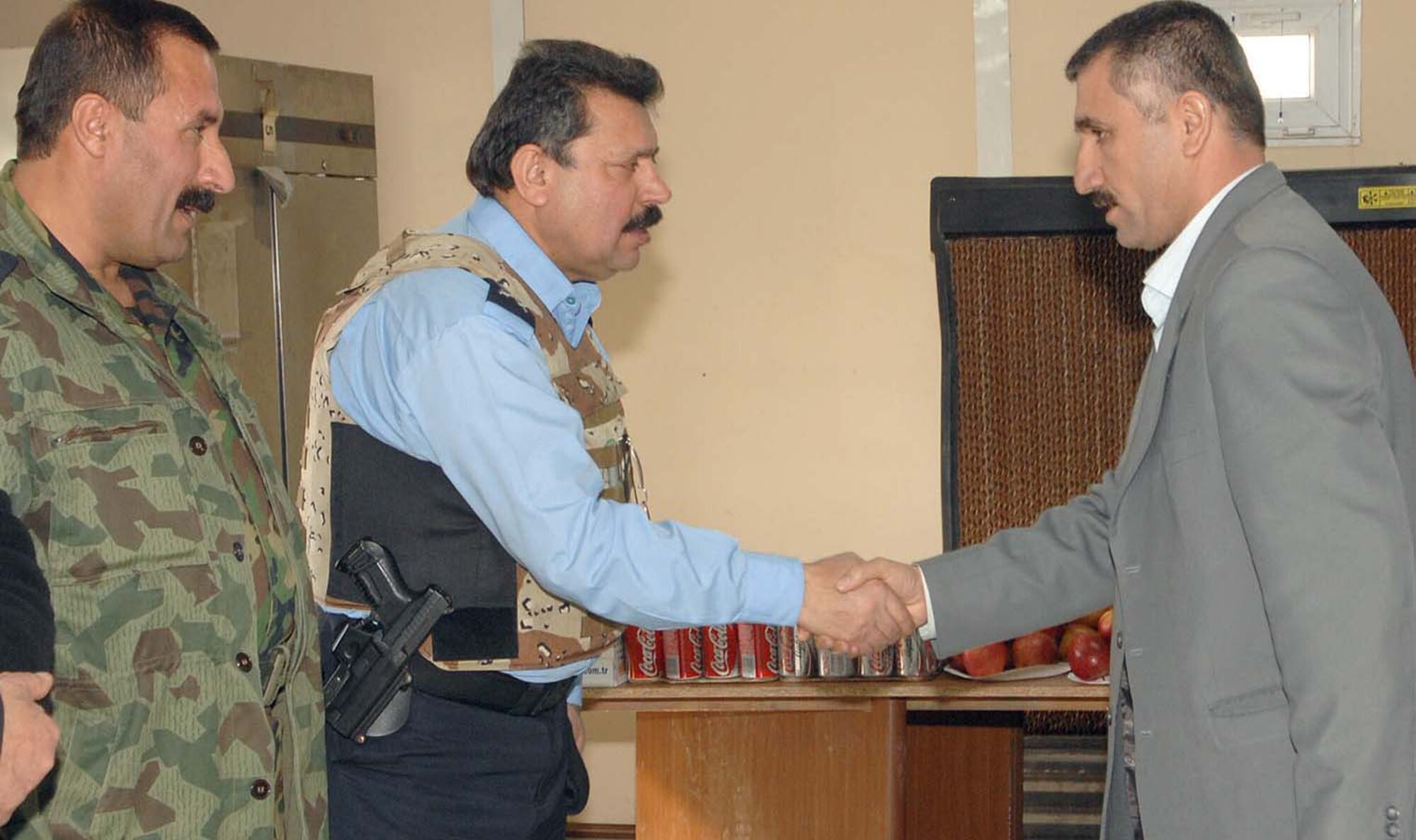 Maj. Gen. Jamal Taher Bakir, top police chief for the city of Kirkuk, congratulates a Senior Law Enforcement Staff Management course attendee during a ceremony recently. The course was the first-of-its-kind for police throughout Iraq, and provides a positive outlook for future stability and security in Kirkuk. (U.S. Air Force photo by Senior Airman SerMae Lampkin)