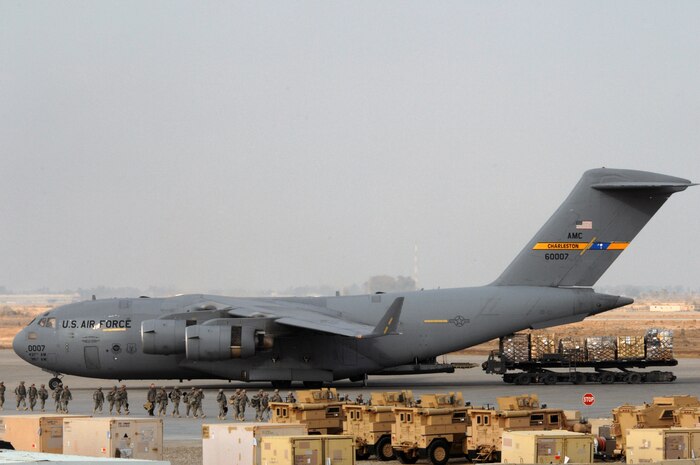 Pallets of cargo are downloaded from a Charleston Air Force Base, S.C., C-17 Globemaster III at Sather Air Base, Iraq, Jan. 21. Sather AB is located on the west side of Baghdad International Airport and is the largest mover of passengers in Iraq, averaging more than 6,200 passengers weekly, and is the second largest mover of cargo in Iraq, averaging more than 1,700  tons weekly. (U.S. Air Force photo / Tech. Sgt. Jeffrey Allen)