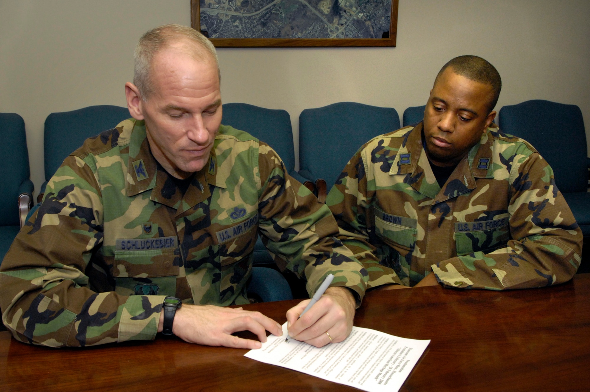 HANSCOM AFB, Mass. – Col. Tom Schluckebier (left), 66th Air Base Wing commander, signs the Black History Month proclamation while Capt. Robert Brown, 850th Electronic Systems Group looks on. Throughout February the base community is invited to attend the many events and activities planned to recognize and celebrate the achievements and contributions of black Americans. (U.S. Air Force photo by Mark Wyatt)