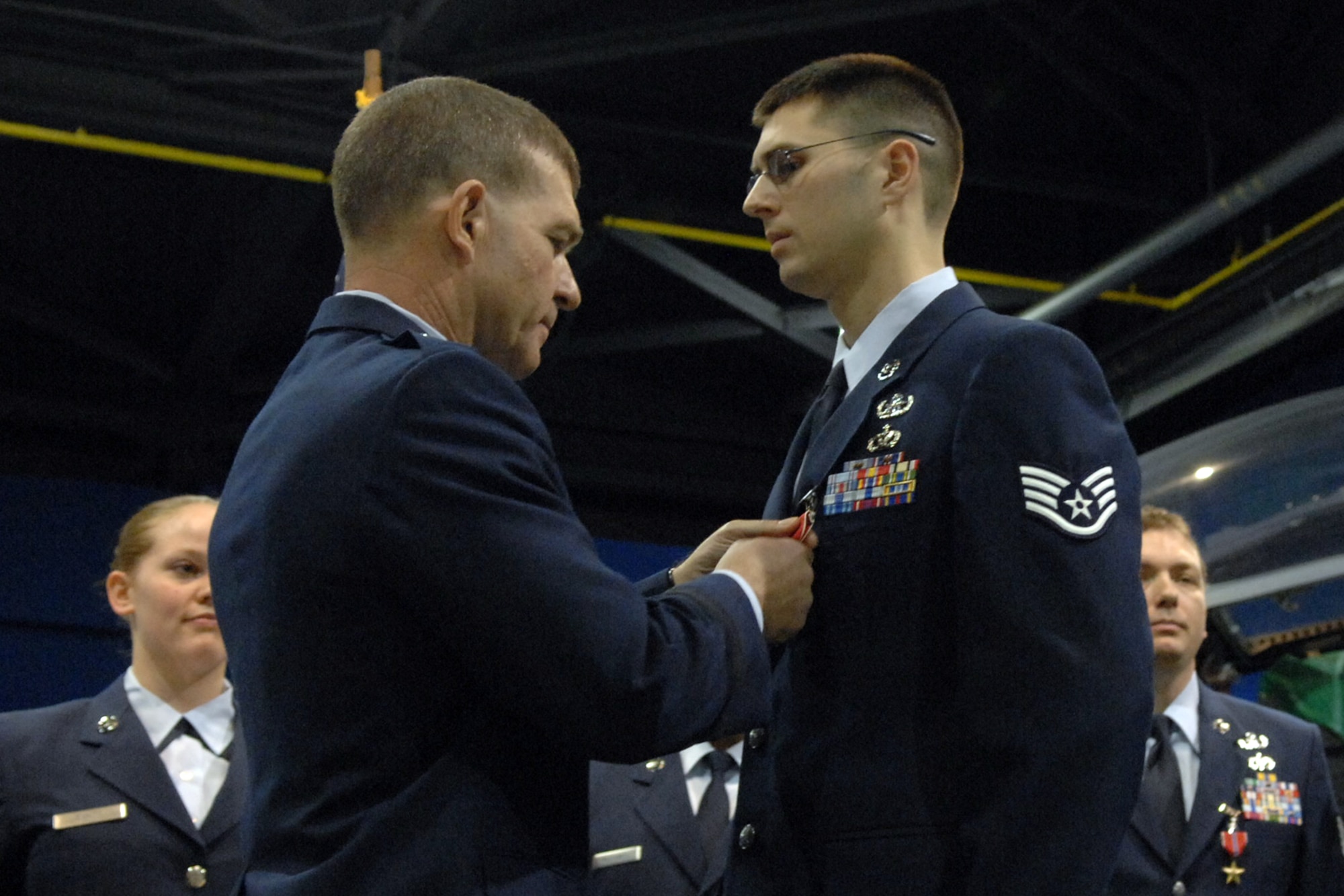 LANGLEY AIR FORCE BASE, Va. -- Brig. Gen. Mark A. Barrett, 1st Fighter Wing Commander, awards Staff Sgt. Keith Schulz, 1st Civil Engineer Squadron, with a Bronze Star for his meritorious service at Balad Air Base, Iraq. The Bronze Star is awarded to military members who have distinguished themselves with meritorious service and acts of heroism against an armed enemy. (U.S. Air Force photo/Airman 1st Class Vernon Young)