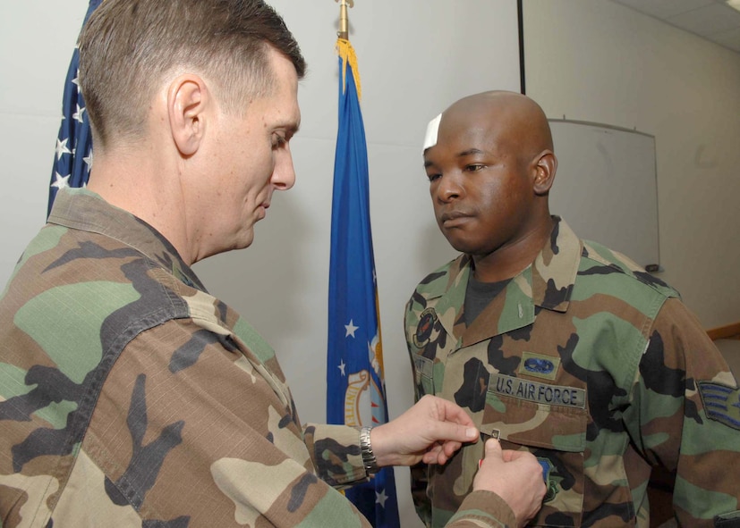 Col. Timothy Ray, 7th Bomb Wing commander, pins the Bronze Star Medal on Staff Sgt. Roberto Short Jan. 29. Sergeant Short received the medal for his intelligence actions in Iraq. (U.S. Air Force photo by Airman 1st Class Stephen Reyes)