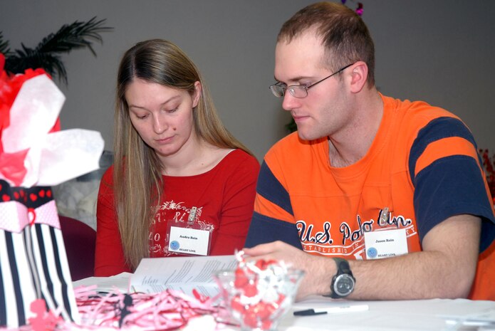 Airman 1st Class Jason Bain, 437th Aerial Port Squadron, and his wife, Audra, review an information booklet during the Heart Link orientation program, Jan. 26, at the Charleston AFB Airman and Family Readiness Flight. (U.S. Air Force photo / Staff Sgt. Jennifer Arredondo)