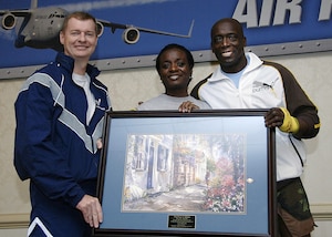 Col. John "Red" Millander (left), 437th Airlift Wing commander, and Billy Blanks, national fitness trainer, present Tech. Sgt. Denese Bellamy, 437th Airlift Wing Military Equal Opportunity Office, a volunteer recognition award Jan. 29 at the Charleston Club. Sergeant Bellamy has been a certified aerobics/indoor cycling instructor and has been volunteering at the Fitness and Sports center since her arrival to Charleston AFB in 1999.  (U.S. Air Force photo/Airman 1st Class Katie Gieratz)